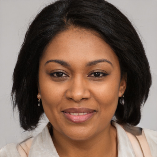 Joyful black young-adult female with medium  brown hair and brown eyes
