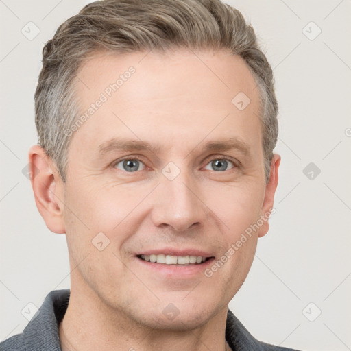 Joyful white adult male with short  brown hair and grey eyes