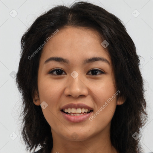 Joyful latino young-adult female with long  brown hair and brown eyes