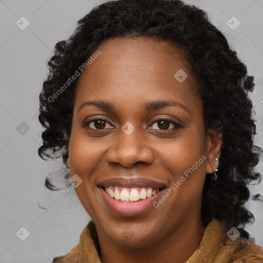 Joyful black young-adult female with long  brown hair and brown eyes