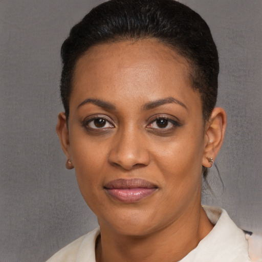 Joyful black young-adult female with short  black hair and brown eyes