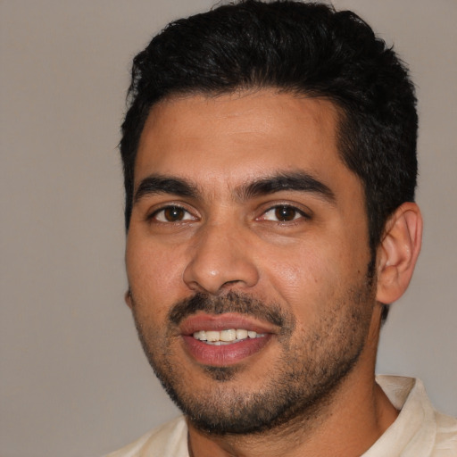 Joyful latino young-adult male with short  black hair and brown eyes