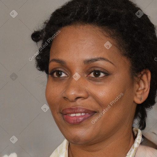 Joyful black adult female with medium  brown hair and brown eyes