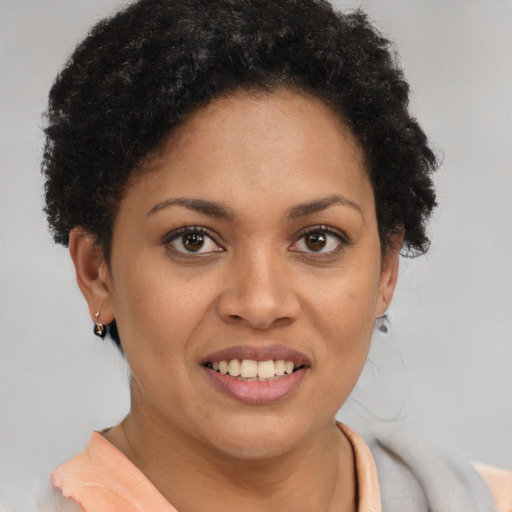 Joyful latino young-adult female with short  brown hair and brown eyes