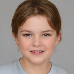 Joyful white child female with medium  brown hair and brown eyes