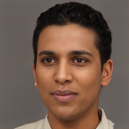 Joyful latino young-adult male with short  black hair and brown eyes