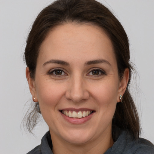 Joyful white young-adult female with medium  brown hair and brown eyes