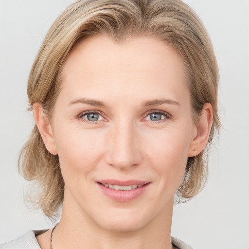 Joyful white young-adult female with medium  brown hair and blue eyes