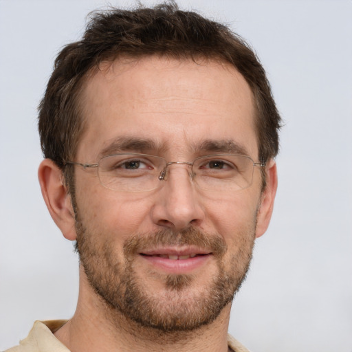 Joyful white adult male with short  brown hair and brown eyes