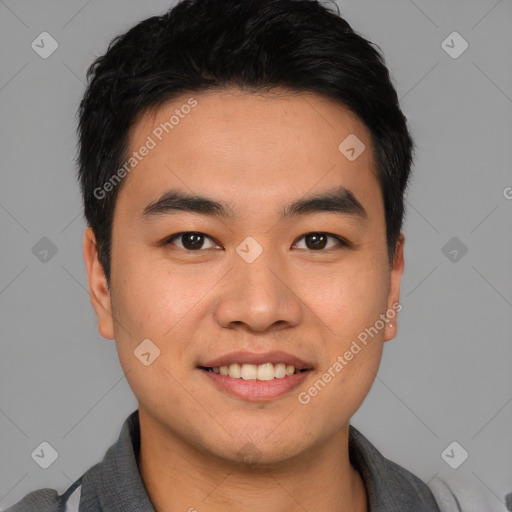 Joyful asian young-adult male with short  brown hair and brown eyes