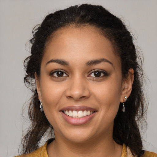 Joyful latino young-adult female with long  brown hair and brown eyes