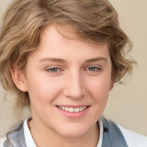 Joyful white young-adult female with medium  brown hair and blue eyes