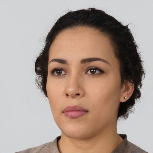 Neutral latino young-adult female with short  black hair and brown eyes