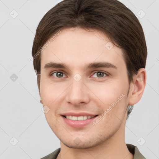 Joyful white young-adult male with short  brown hair and grey eyes