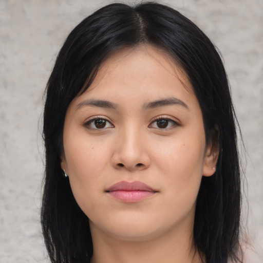 Joyful asian young-adult female with long  black hair and brown eyes