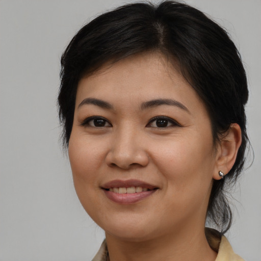 Joyful asian young-adult female with medium  brown hair and brown eyes