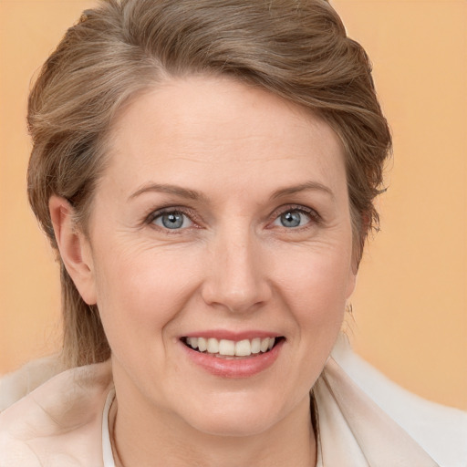 Joyful white adult female with medium  brown hair and blue eyes