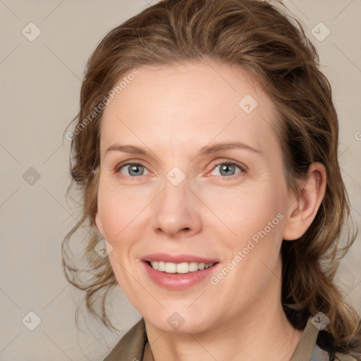 Joyful white young-adult female with medium  brown hair and blue eyes