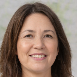 Joyful white adult female with long  brown hair and brown eyes