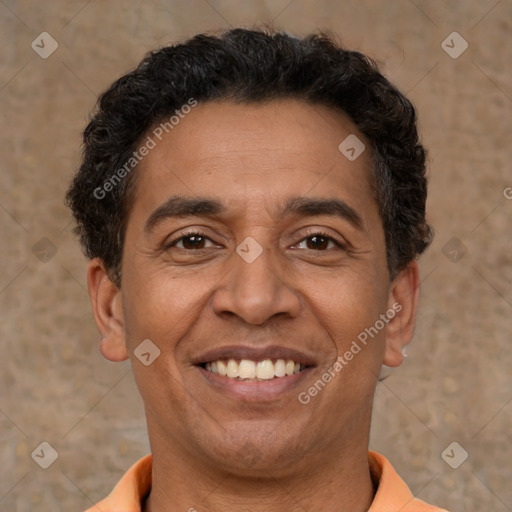 Joyful latino adult male with short  brown hair and brown eyes