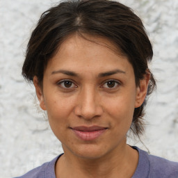 Joyful white adult female with medium  brown hair and brown eyes