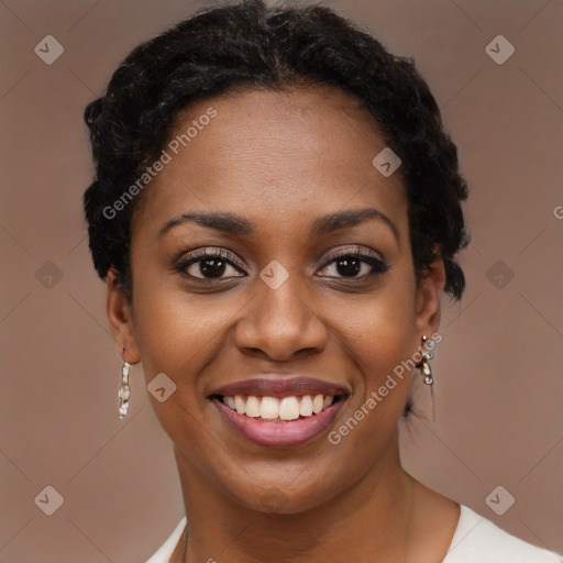 Joyful black young-adult female with short  black hair and brown eyes