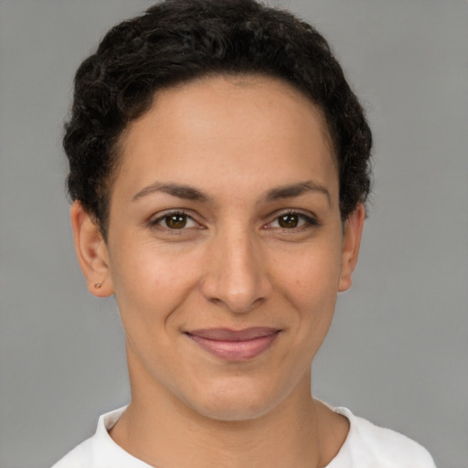 Joyful latino young-adult female with short  brown hair and brown eyes