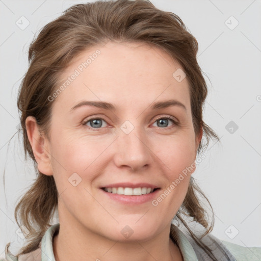 Joyful white young-adult female with medium  brown hair and blue eyes