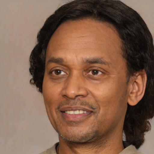 Joyful latino adult male with short  brown hair and brown eyes