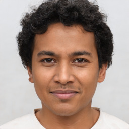 Joyful latino young-adult male with short  brown hair and brown eyes