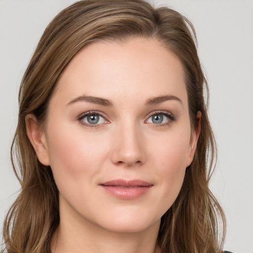 Joyful white young-adult female with long  brown hair and blue eyes