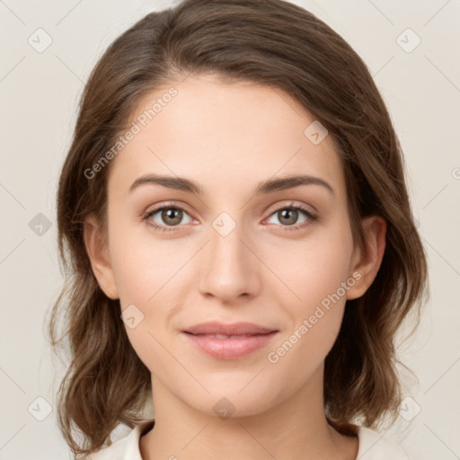 Joyful white young-adult female with medium  brown hair and green eyes