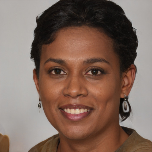 Joyful black young-adult female with medium  brown hair and brown eyes