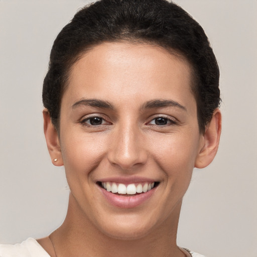 Joyful white young-adult female with short  brown hair and brown eyes