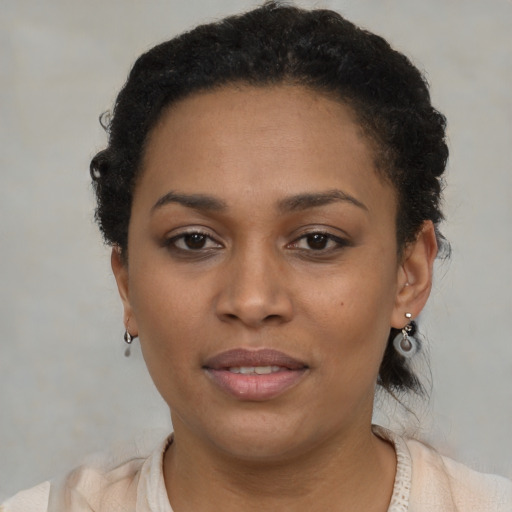 Joyful black young-adult female with short  brown hair and brown eyes