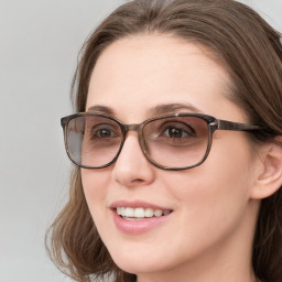 Joyful white young-adult female with long  brown hair and blue eyes