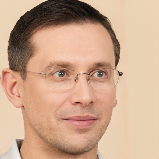 Joyful white adult male with short  brown hair and brown eyes