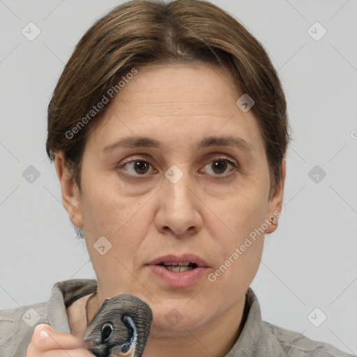 Joyful white adult female with short  brown hair and grey eyes