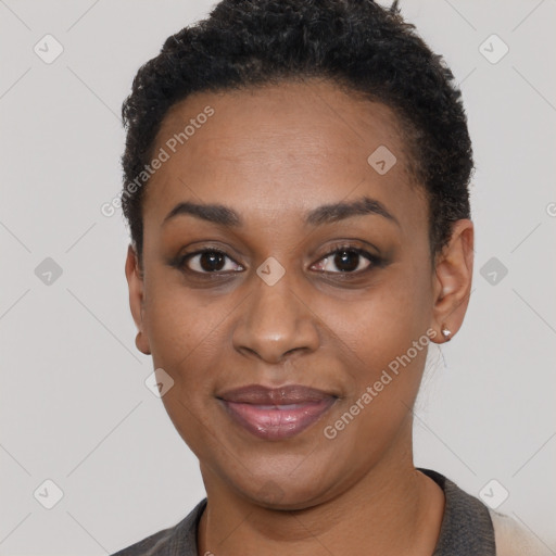 Joyful black young-adult female with short  black hair and brown eyes