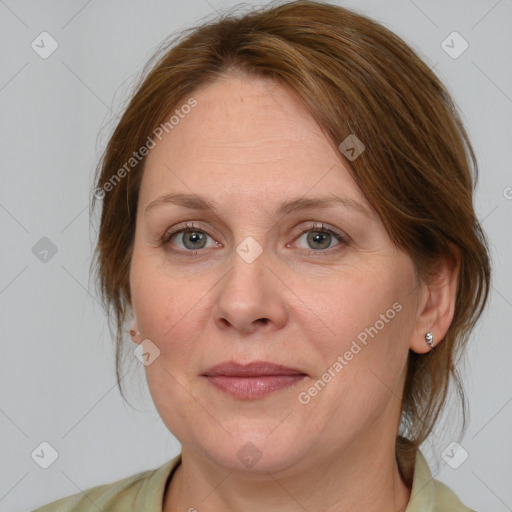 Joyful white adult female with medium  brown hair and blue eyes