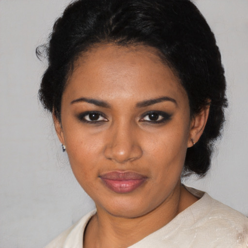 Joyful black young-adult female with medium  black hair and brown eyes