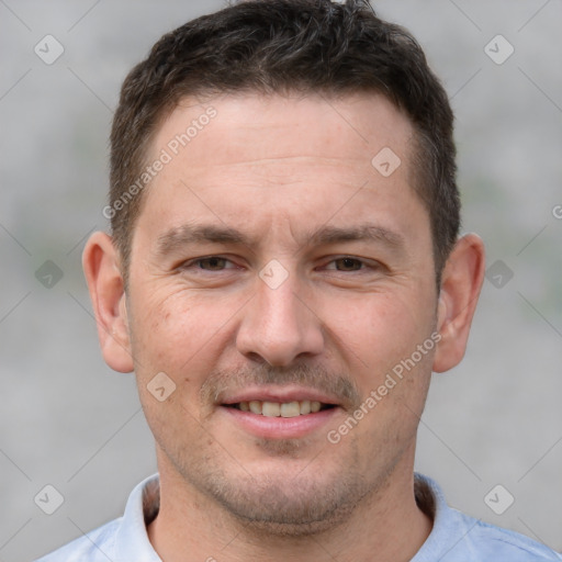 Joyful white adult male with short  brown hair and brown eyes