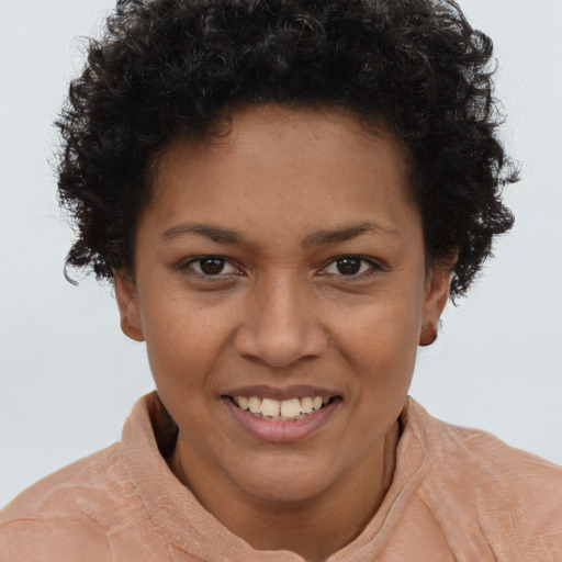 Joyful black young-adult female with short  brown hair and brown eyes