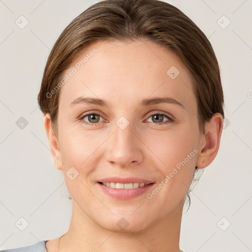 Joyful white young-adult female with short  brown hair and grey eyes