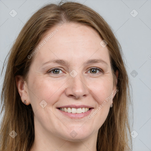 Joyful white adult female with long  brown hair and grey eyes