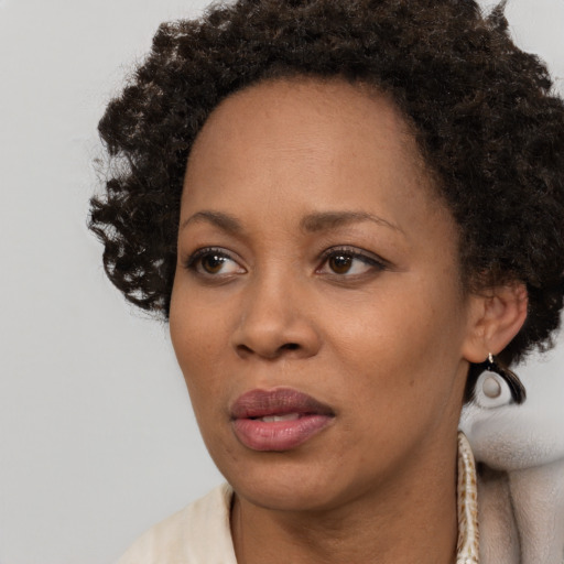 Neutral black young-adult female with short  brown hair and brown eyes