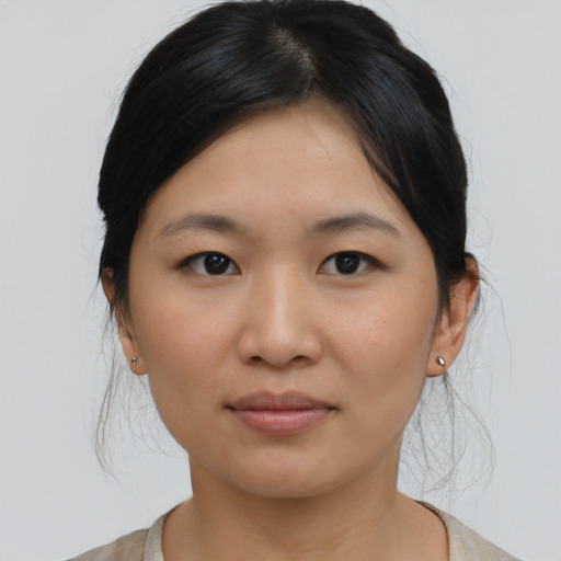 Joyful asian young-adult female with medium  black hair and brown eyes