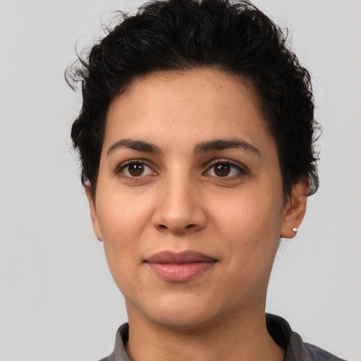 Joyful latino young-adult female with short  black hair and brown eyes