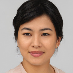 Joyful asian young-adult female with medium  black hair and brown eyes