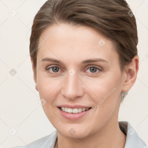 Joyful white young-adult female with short  brown hair and grey eyes